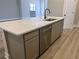 Kitchen island with sink, dishwasher, and white quartz countertop at 5479 Brussels Ter, Port Charlotte, FL 33981