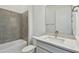 Bathroom with gray tile and quartz countertop at 9457 Barnacle Ln, Parrish, FL 34219