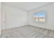 Simple bedroom with gray carpet and large window at 9457 Barnacle Ln, Parrish, FL 34219