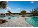 Resort-style pool with lounge chairs and palm trees at 10896 Ibis Brook Ct, Land O Lakes, FL 34638