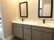 Double vanity bathroom with quartz countertops and gray cabinets at 12140 Warden Ave, Port Charlotte, FL 33981