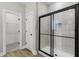 Modern bathroom featuring a glass-enclosed shower with white tile and a separate door to the closet at 12140 Warden Ave, Port Charlotte, FL 33981