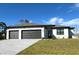 New construction home with three-car garage and attractive landscaping at 12140 Warden Ave, Port Charlotte, FL 33981