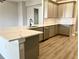 L-shaped kitchen island with white quartz countertop and gray cabinets at 12140 Warden Ave, Port Charlotte, FL 33981