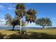 Scenic waterfront park with picnic tables, palm trees, and tranquil water views at 12140 Warden Ave, Port Charlotte, FL 33981