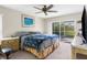 Bright bedroom with a king-size bed and access to a screened patio at 2833 Windridge Dr, Holiday, FL 34691