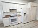 White kitchen with stainless steel appliances and ample counter space at 17820 Monteverde Dr, Spring Hill, FL 34610