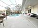 Spacious pool patio with a hanging swing chair at 17820 Monteverde Dr, Spring Hill, FL 34610