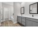 Elegant bathroom featuring double vanity sinks, gray cabinets, and a separate tub and shower area at 4570 Gillot Blvd, Port Charlotte, FL 33981