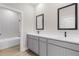 Bathroom featuring double sinks, grey cabinetry, and modern black fixtures at 4570 Gillot Blvd, Port Charlotte, FL 33981