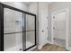 Modern bathroom features a glass-enclosed shower with black hardware and a neutral tile surround at 4570 Gillot Blvd, Port Charlotte, FL 33981