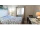 Bedroom with coastal bedding and sliding glass doors at 4154 Heron Way # 203B, Bradenton, FL 34205