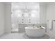 Luxurious bathroom with marble tile, a soaking tub, and a large walk-in shower at 4835 W San Jose St, Tampa, FL 33629