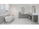 Modern bathroom with gray cabinetry, dual sinks and a large mirror at 4835 W San Jose St, Tampa, FL 33629