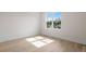 Bright bedroom featuring hardwood floors and a large window at 4835 W San Jose St, Tampa, FL 33629