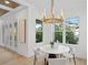 Bright breakfast nook with a round table and four chairs, offering natural light and elegant chandelier at 4835 W San Jose St, Tampa, FL 33629