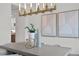 Elegant dining room showcases a statement chandelier and modern art above a concrete table at 4835 W San Jose St, Tampa, FL 33629