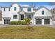 Two-story white farmhouse with gray accents, two-car garage, and manicured lawn at 4835 W San Jose St, Tampa, FL 33629
