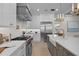 Open concept kitchen with island, stainless steel appliances, and white cabinets at 4835 W San Jose St, Tampa, FL 33629