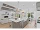 Open concept kitchen and living area, featuring a kitchen island and fireplace at 4835 W San Jose St, Tampa, FL 33629