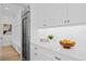 White kitchen with stainless steel appliances and built-in pantry at 4835 W San Jose St, Tampa, FL 33629