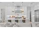 Spacious kitchen with white cabinets, large island, and stainless steel appliances at 4835 W San Jose St, Tampa, FL 33629