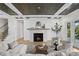 Living room with a cozy fireplace, hardwood floors, and large windows at 4835 W San Jose St, Tampa, FL 33629