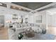 Open living space with sectional sofa, hardwood floors, and kitchen views at 4835 W San Jose St, Tampa, FL 33629