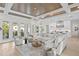 Spacious living room features a sectional sofa, coffered ceiling, and access to backyard at 4835 W San Jose St, Tampa, FL 33629