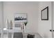 Home office with white table, coastal artwork, and a large mirror at 4835 W San Jose St, Tampa, FL 33629
