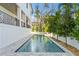 Relaxing backyard featuring a private pool, mature trees, and modern home architecture at 4835 W San Jose St, Tampa, FL 33629