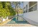 Inviting backyard pool with spa, surrounded by lush landscaping and elegant travertine tile at 4835 W San Jose St, Tampa, FL 33629