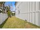 Landscaped side yard with grassy area and white fence at 4835 W San Jose St, Tampa, FL 33629