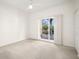 Bright bedroom with sliding doors leading to a balcony at 1188 N Tamiami Trl # 201, Sarasota, FL 34236