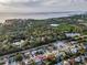 Aerial view showcasing home's location in a residential neighborhood near the water at 1619 Coppertree Dr, Tarpon Springs, FL 34689