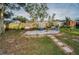 Sand fire pit area with seating in the backyard at 1619 Coppertree Dr, Tarpon Springs, FL 34689