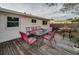 Outdoor dining area on deck overlooking backyard at 1619 Coppertree Dr, Tarpon Springs, FL 34689