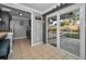 Well-lit kitchen with tile floor, gray cabinets, stainless steel appliances, and sliding door to the backyard at 1619 Coppertree Dr, Tarpon Springs, FL 34689