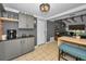 Modern kitchen with gray cabinets and exposed wooden beams at 1619 Coppertree Dr, Tarpon Springs, FL 34689