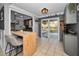 Bright kitchen with gray cabinets, a breakfast bar, and sliding glass doors leading to the deck and backyard at 1619 Coppertree Dr, Tarpon Springs, FL 34689