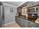 Modern kitchen with gray cabinets and black countertops at 1619 Coppertree Dr, Tarpon Springs, FL 34689