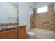 Bathroom with tub, shower, granite countertop and wood cabinets at 649 Chipper Dr, Sun City Center, FL 33573