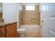 Bathroom with tub, shower, granite countertop and wood cabinets at 649 Chipper Dr, Sun City Center, FL 33573