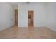 Bedroom with tile floors and doors to bathroom and hallway at 649 Chipper Dr, Sun City Center, FL 33573