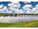 Aerial view of a lakefront community with houses and lush green lawns at 649 Chipper Dr, Sun City Center, FL 33573