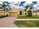 Two-story house with a three-car garage and landscaped front yard at 649 Chipper Dr, Sun City Center, FL 33573