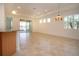 Bright living room with tile floors, sliding glass doors, and a ceiling fan at 649 Chipper Dr, Sun City Center, FL 33573