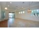 Bright living room with tile floors, sliding glass doors, and a ceiling fan at 649 Chipper Dr, Sun City Center, FL 33573