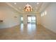 Spacious living room featuring tile floors and a stained-glass light fixture at 649 Chipper Dr, Sun City Center, FL 33573