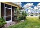 Relaxing screened patio overlooking a pond, featuring lush landscaping and brick pavers at 649 Chipper Dr, Sun City Center, FL 33573